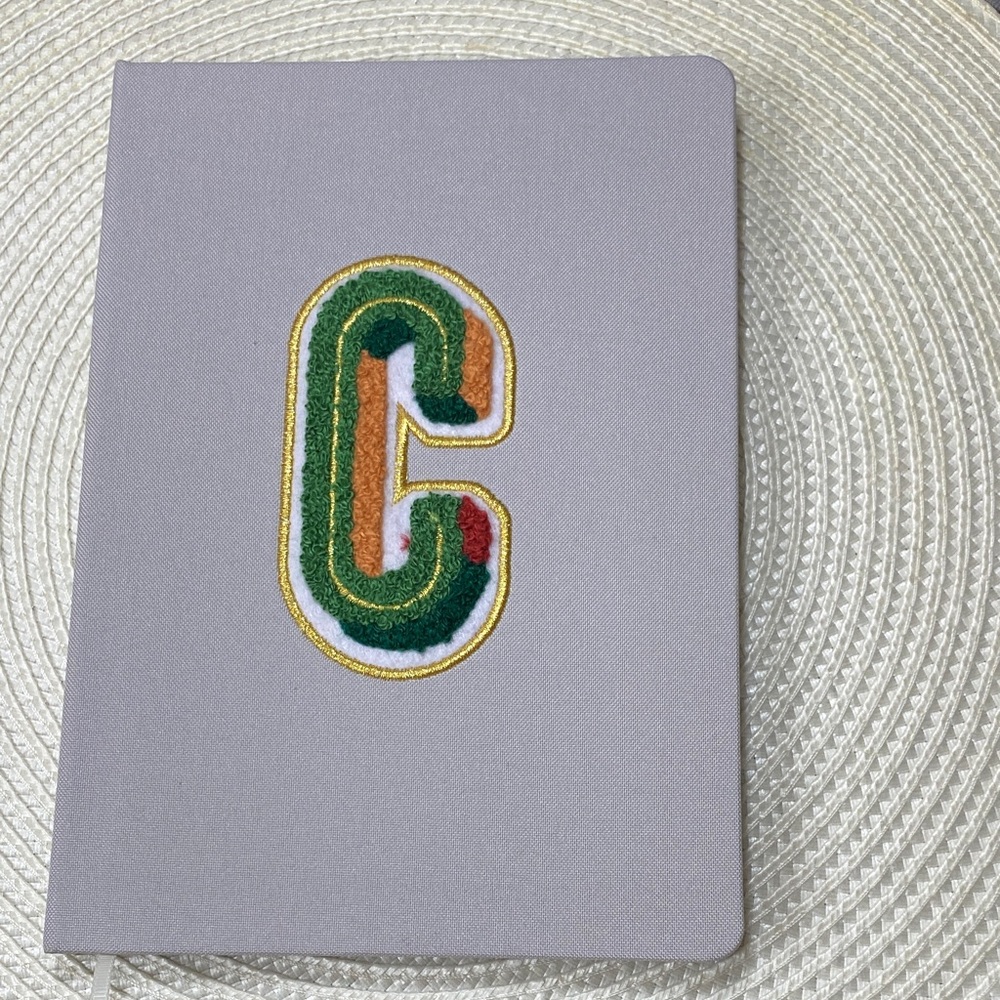 Gray Notebook with Colorful 'C' Patch